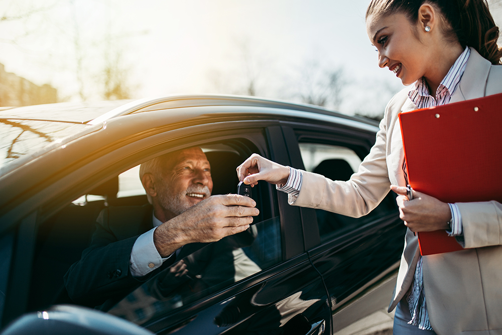 Car dealer gives the keys to the new owner